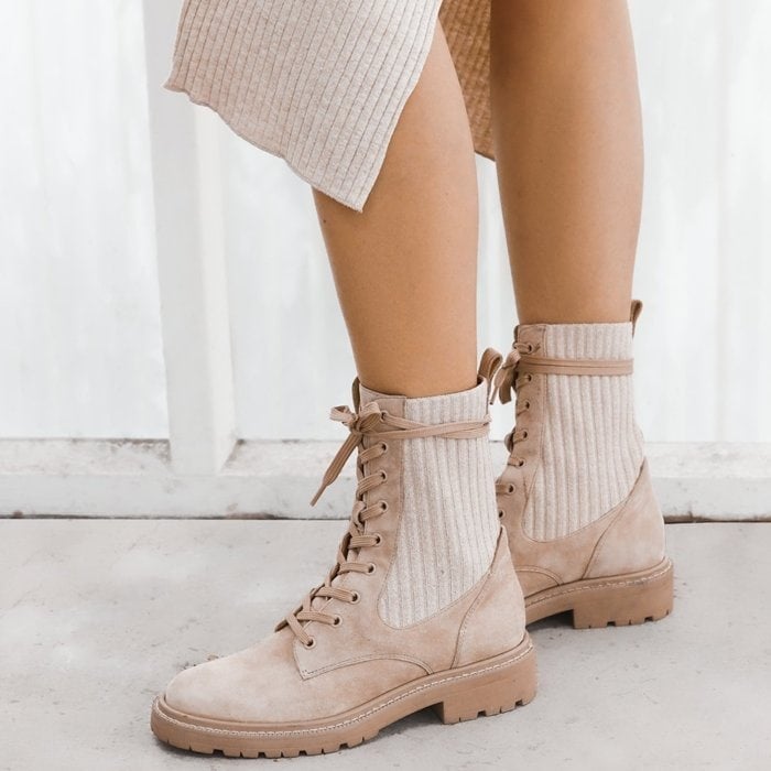 Tough gets cozy on this lug-sole combat boot featuring ribbed knit insets in the shaft that make the fit just right