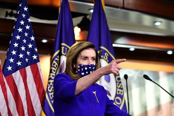 Speaker of the United States House of Representatives Nancy Pelosi wears a face mask