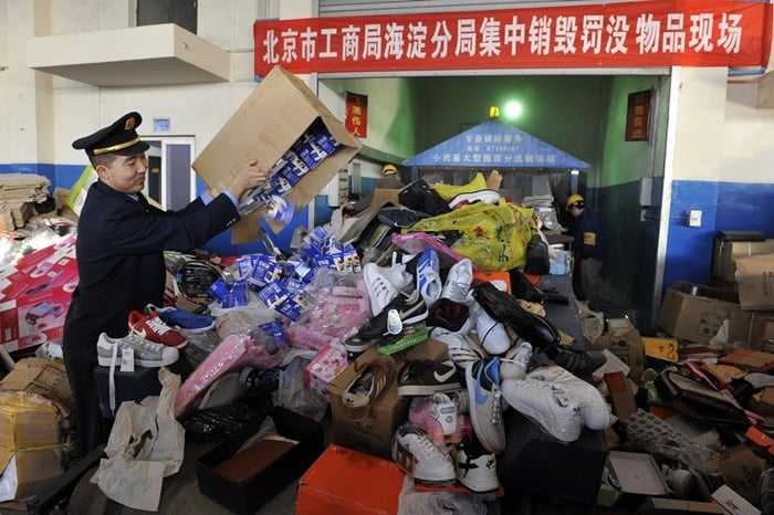 Thousands of fake phones and shoes pile up at a warehouse in China after a massive crackdown on counterfeit goods