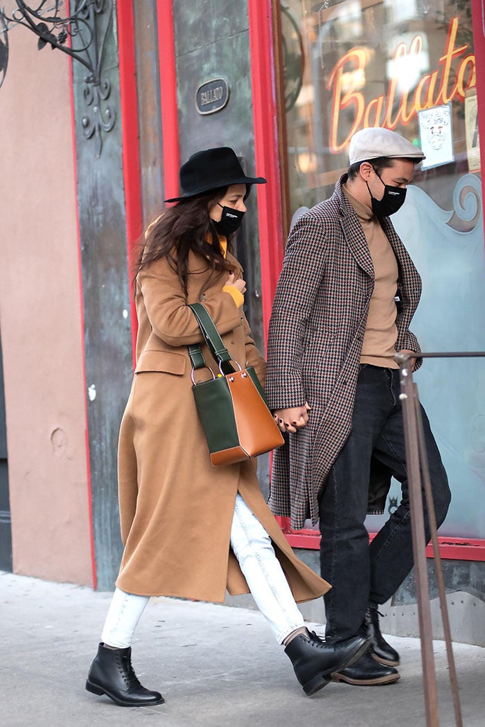 Katie Holmes proves her fall fashion credentials in a Nanushka camel coat with a yellow hoodie and acid-washed jeans