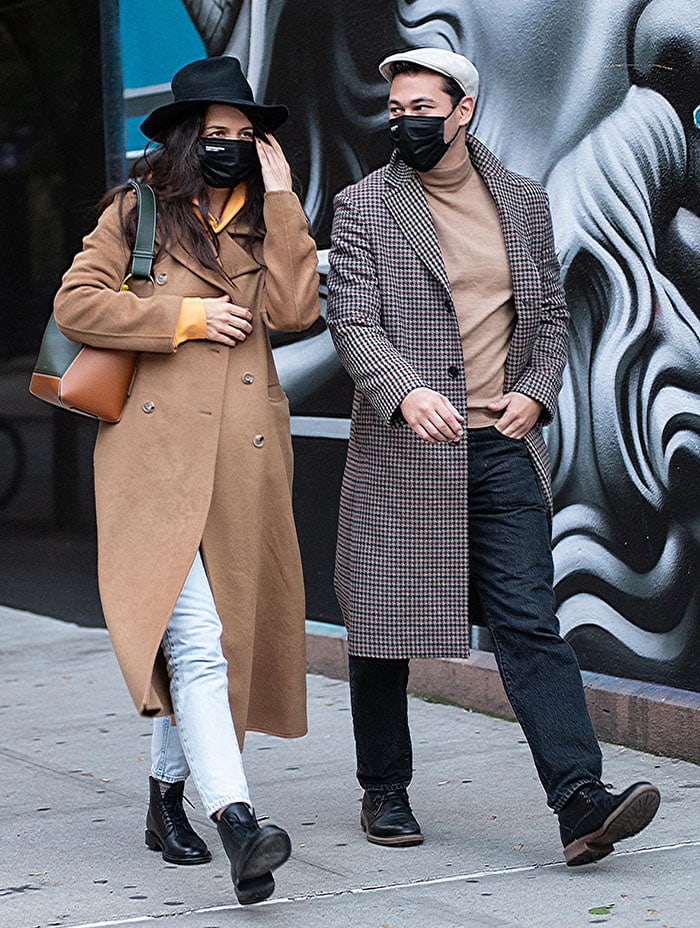 Emilio Vitolo Jr. looks handsome in a houndstooth-patterned coat with beige mock turtleneck top and jeans