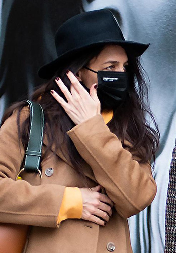 Katie Holmes keeps a low profile with a black fedora hat and a face mask