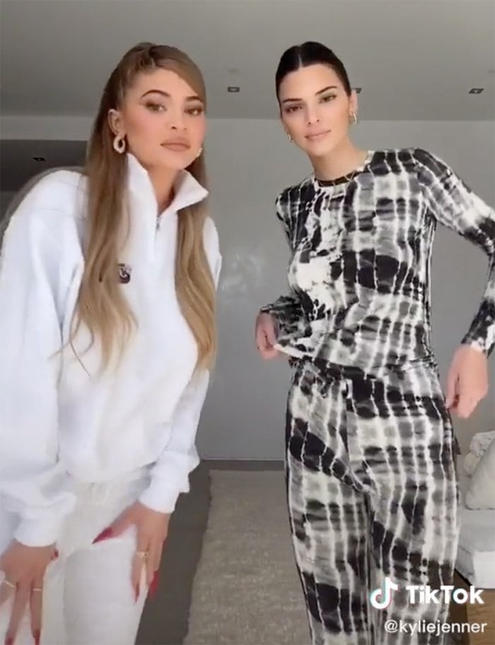 Kylie Jenner dresses in white Swears by Sam sweatpants and pullover while Kendall wears Beau Souci tie-dye co-ords