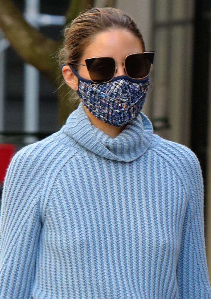 Olivia Palermo styles her look with a blue tweed face mask and Fendi cat-eye sunglasses