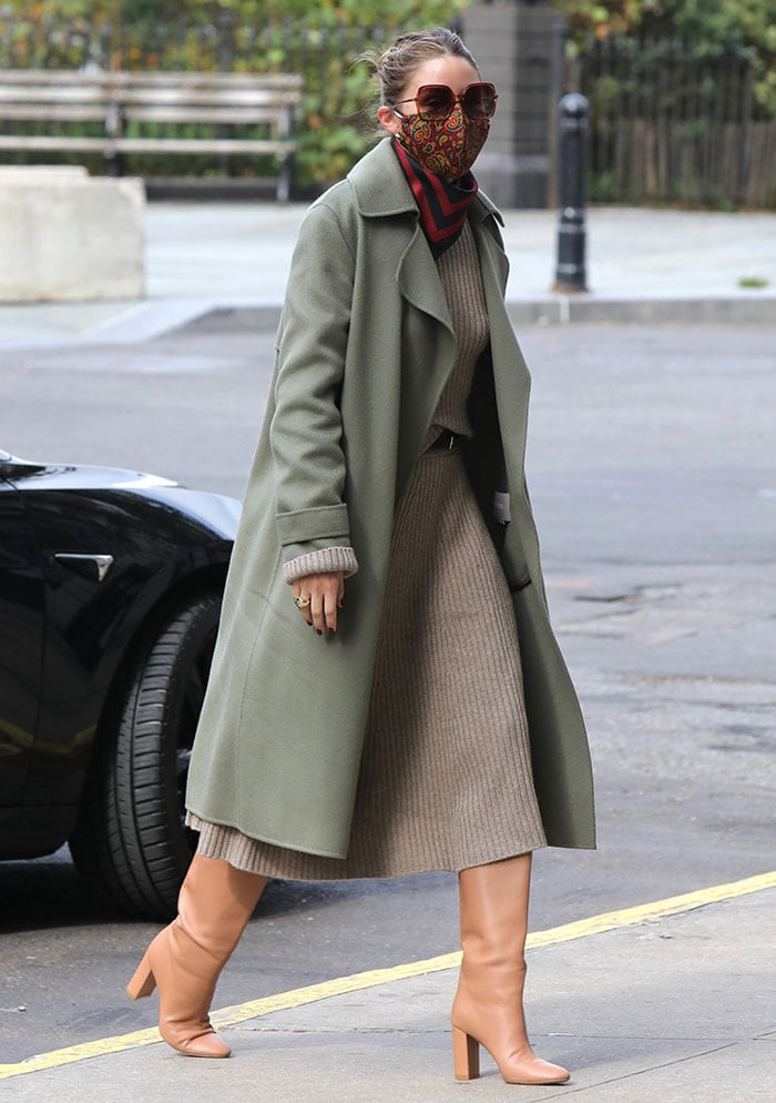 Olivia Palermo wears a gray ribbed knit dress with a khaki green coat