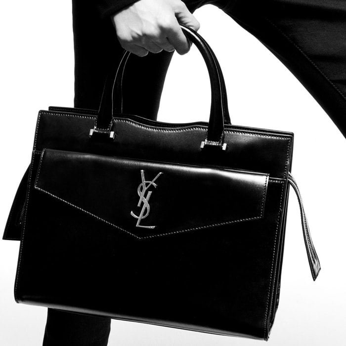 Saint Laurent's 'Uptown' bag is made from smooth glossed-leather with a structured silhouette and is detailed with a tonal monogram