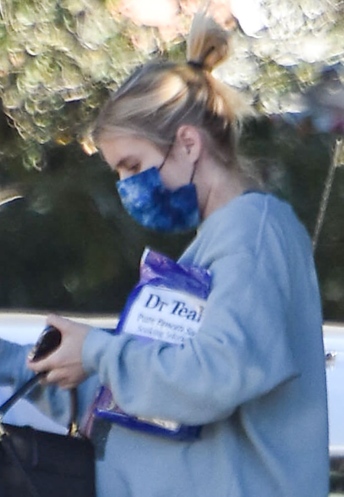 Emma Roberts keeps things low key with a messy bun and barely there makeup