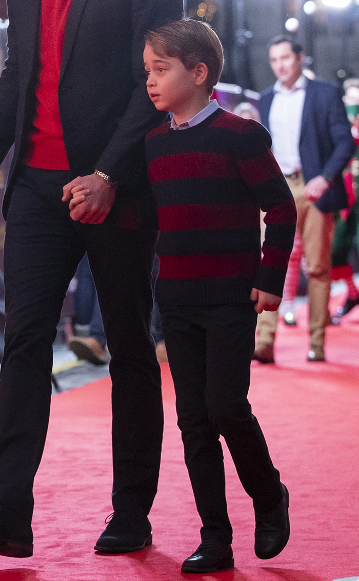 Prince George wears a Ralph Laurent striped sweater with dark jeans and black shoes