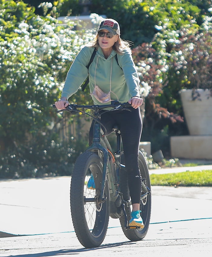 Robin Wright wears a green hoodie with black leggings for the afternoon bike ride