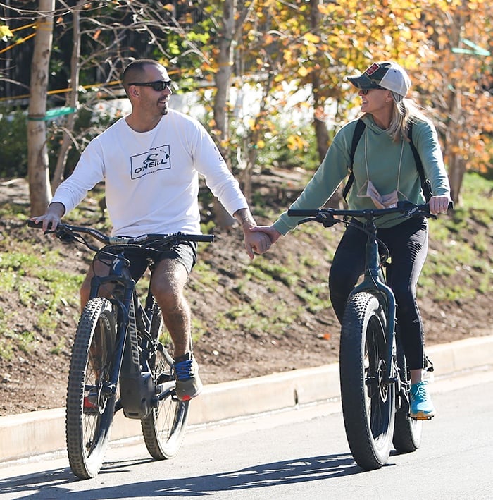 Clément Giraudet holds hands with wife Robin Wright while riding a bike in Los Angeles