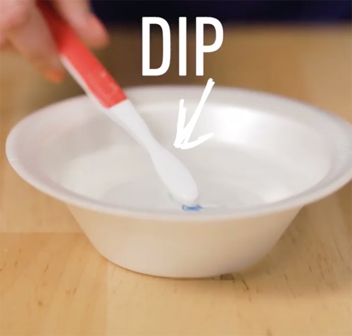 Dip a toothbrush into the mixture