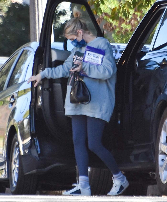 Pregnant Emma Roberts wears a printed blue Barrière face mask while running errands in her Loz Feliz neighborhood