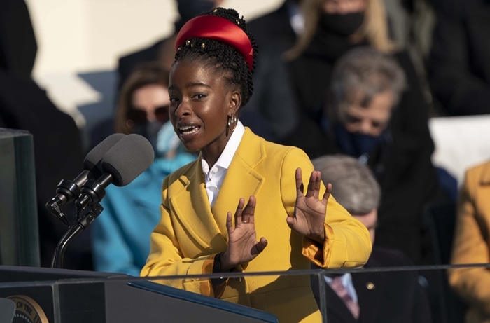 Amanda Gorman wears a sunny-yellow double-breasted natté toile coat from Prada