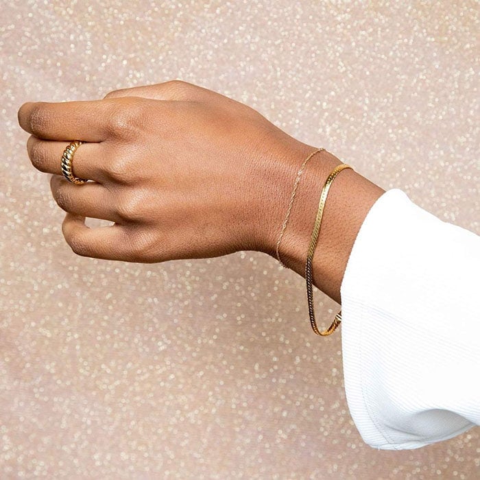 Simple but chic snake chain gold bracelet catches light effortlessly