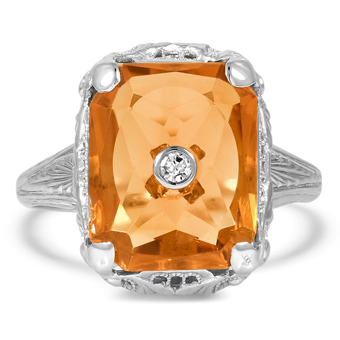 The Vere ring boasts a rectangular citrine with a single-cut diamond accent in the center set in an intricately engraved 14k white gold band