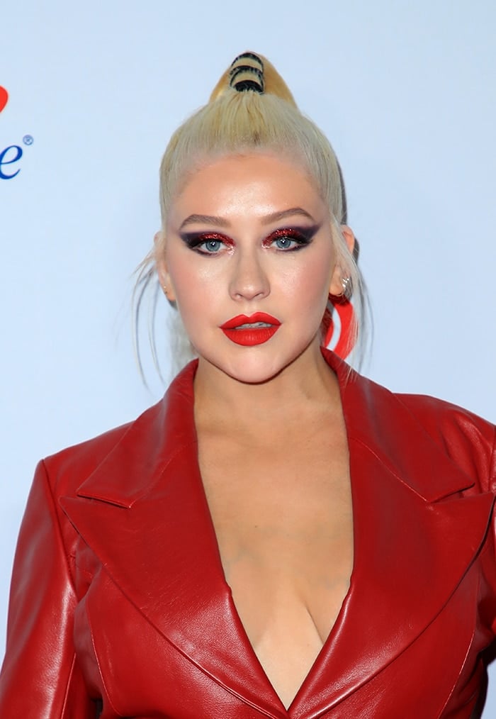 Christina Aguilera is topless in her 16Arlington red leather coat at the iHeartradio Music Festival on September 21, 2019