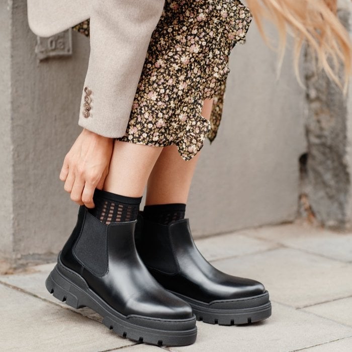 Classic leather Chelsea boots with chunky perforated rubber soles, elasticated side-tabs, and a pull tab at the back