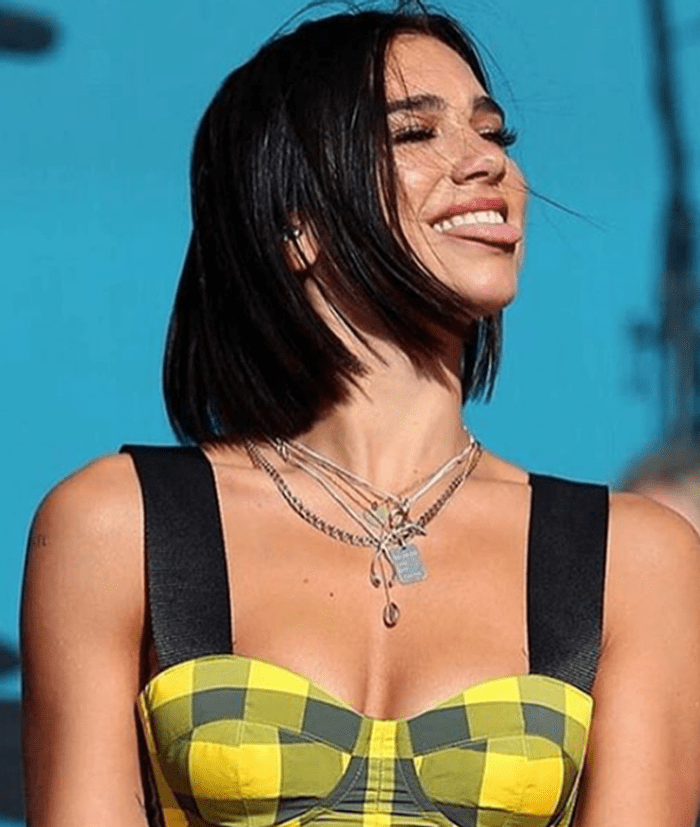 Dua Lipa wearing the Katie Mullally wishbone necklace