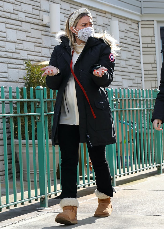 Hilary Duff changes into a cream-colored blouse, Canada Goose parka, and comfier UGG boots