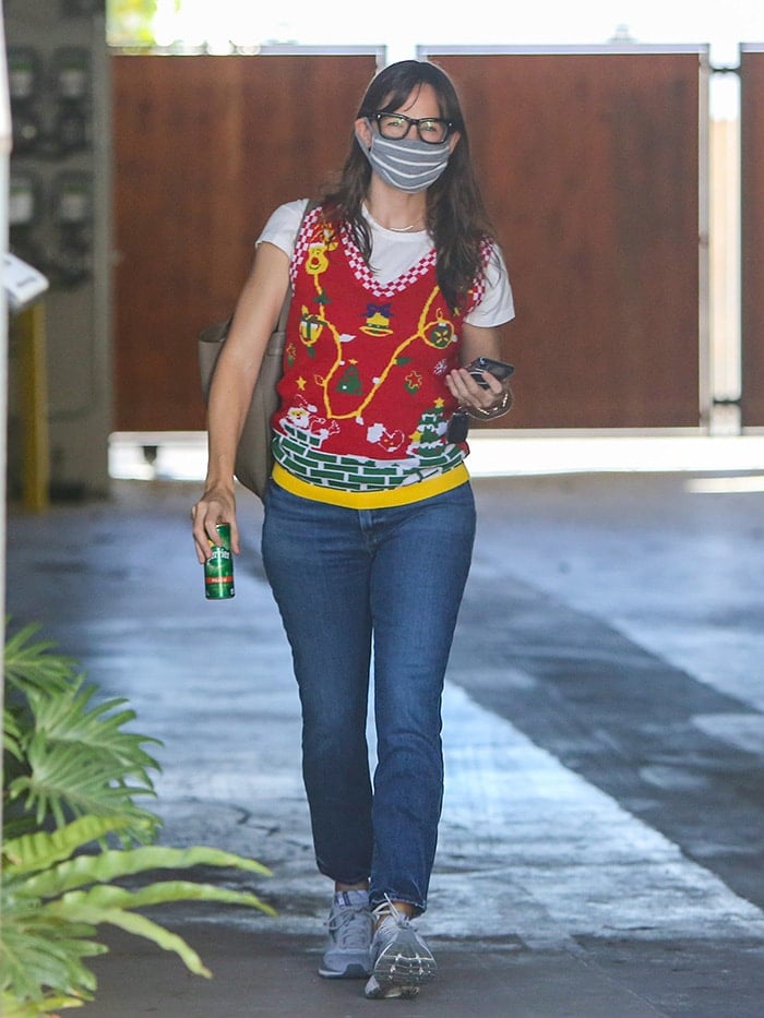 Jennifer Garner in a festive Christmas sweater with a white tee and blue jeans