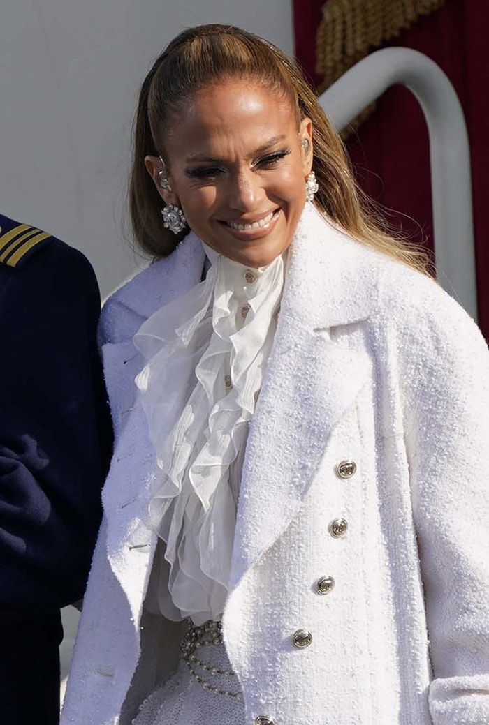 Jennifer Lopez pulls her hair back into a ponytail and styles her look with oversized Chanel earrings