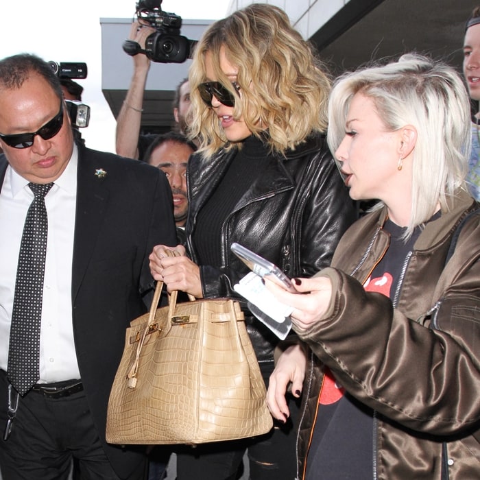 Khloé Kardashian carries a beige crocodile Hermès Birkin handbag
