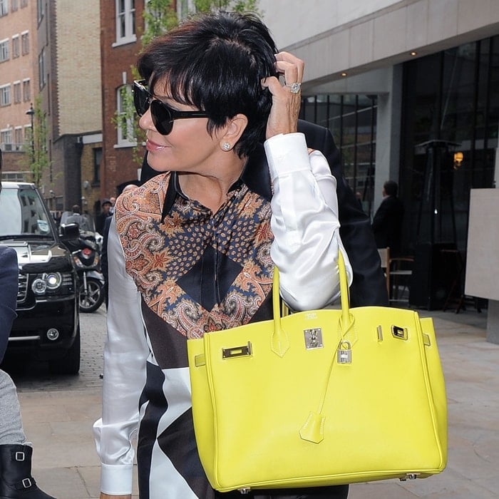 Kris Jenner carries a bright yellow Hermes Birkin bag