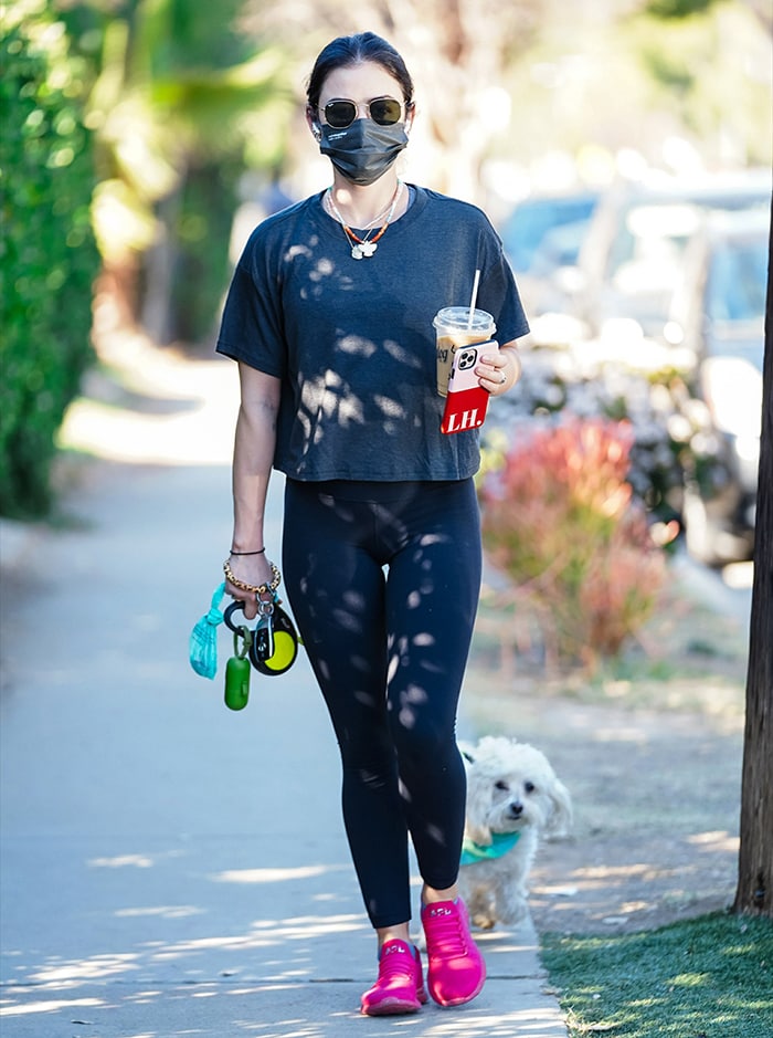 Lucy Hale shows off her toned legs in black leggings and crop top