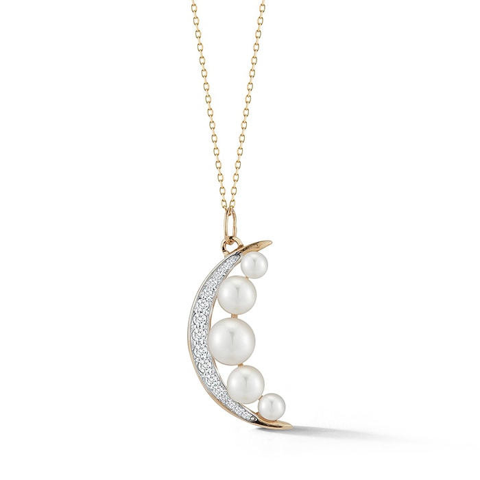 Modernizing cultured freshwater pearls in a diamond-encrusted crescent moon pendant, hanging from a 14kt yellow gold chain