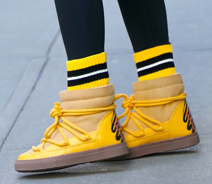 Olivia Palermo adds color to her look with Inuikii yellow sneaker boots