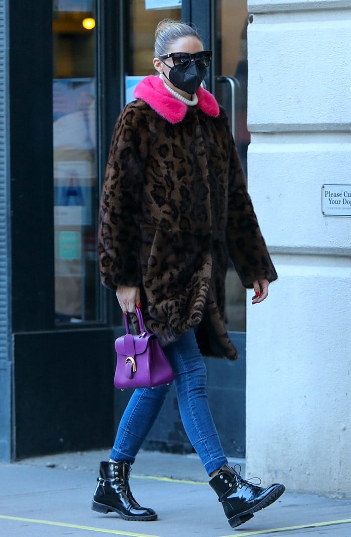 Olivia Palermo teams a pink fur-trimmed leopard-print coat with slim-fit blue jeans