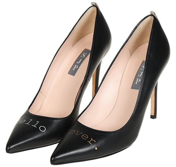 Elevated with a quirky Hello Lover slogan, these classic black leather pumps make a fun statement