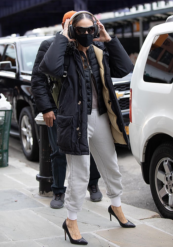 Sarah Jessica Parker bundles up in two layers of outerwear outside her shoe store