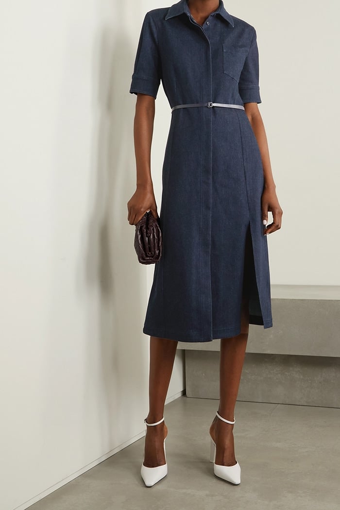 Conservative but chic, this belted denim midi dress has a collar and a modest slit at the knee-grazing hem