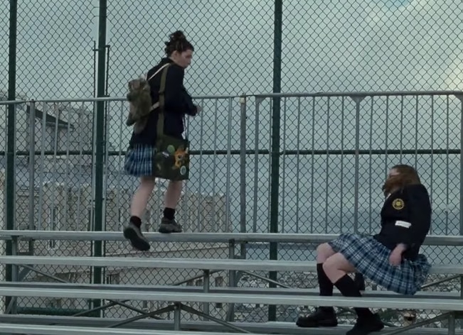 An unplanned moment captured during the bleacher scene in "The Princess Diaries," featuring Anne Hathaway's accidental fall