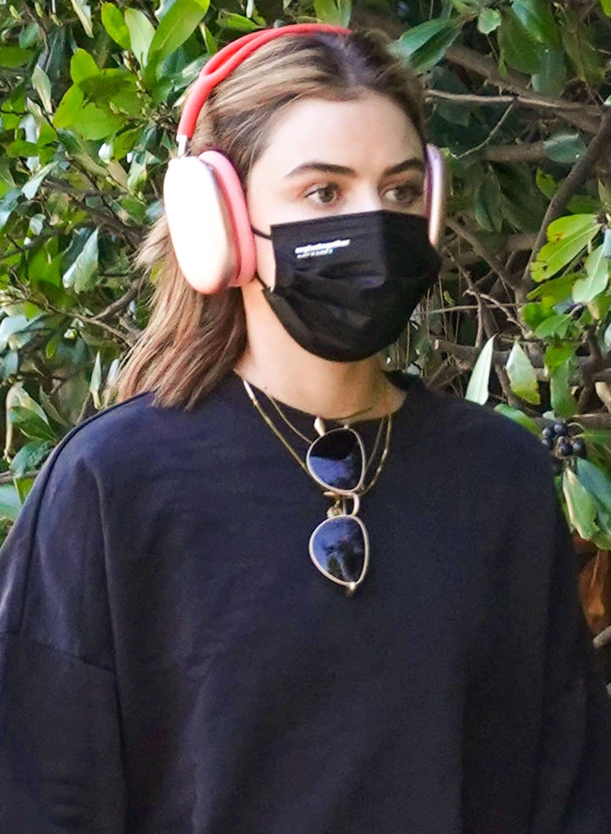 Bare-faced Lucy Hale wears a pair of noise-canceling headphones