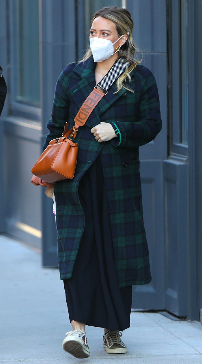 Hilary Duff wears blue-and-green plaid coat and black maxi dress on the Younger set