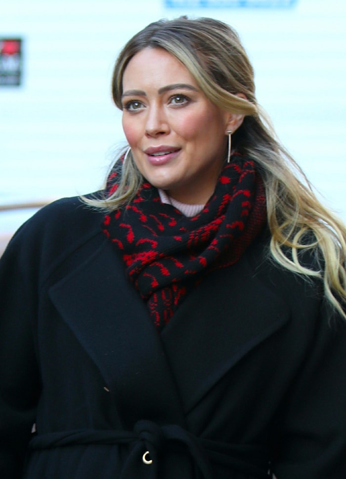 Hilary Duff wears a half-up hairstyle with pink blush and lipstick