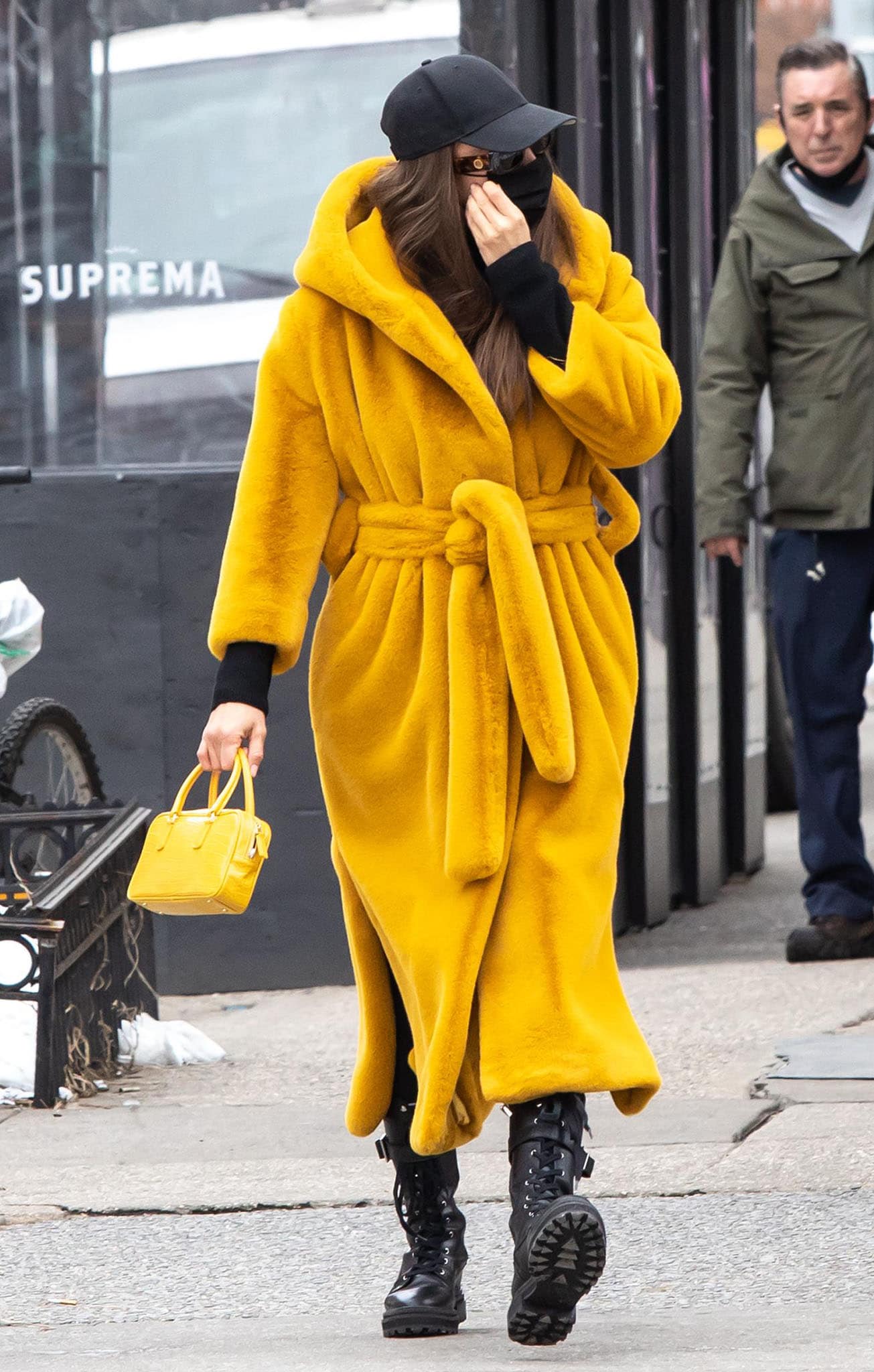 Irina Shayk wears Olēnich faux-fur yellow wrap-style coat with black Intimissimi cashmere leggings