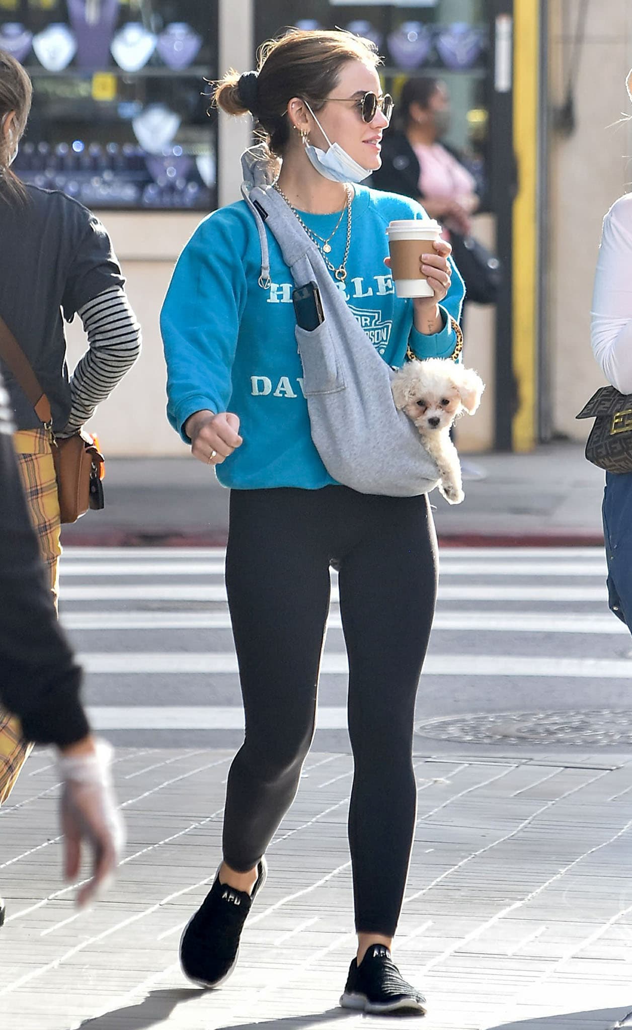 Lucy Hale wears a sky blue Harley Davidson sweatshirt and black leggings