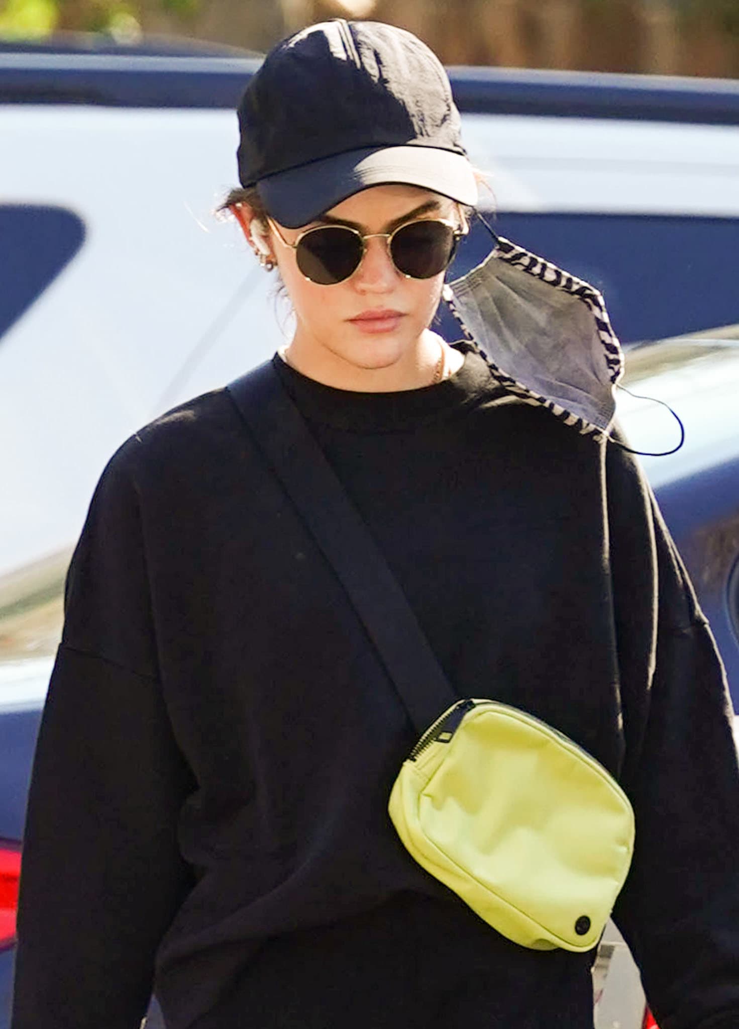 Lucy Hale adds a pop of neon yellow to her look with a Lululemon belt bag