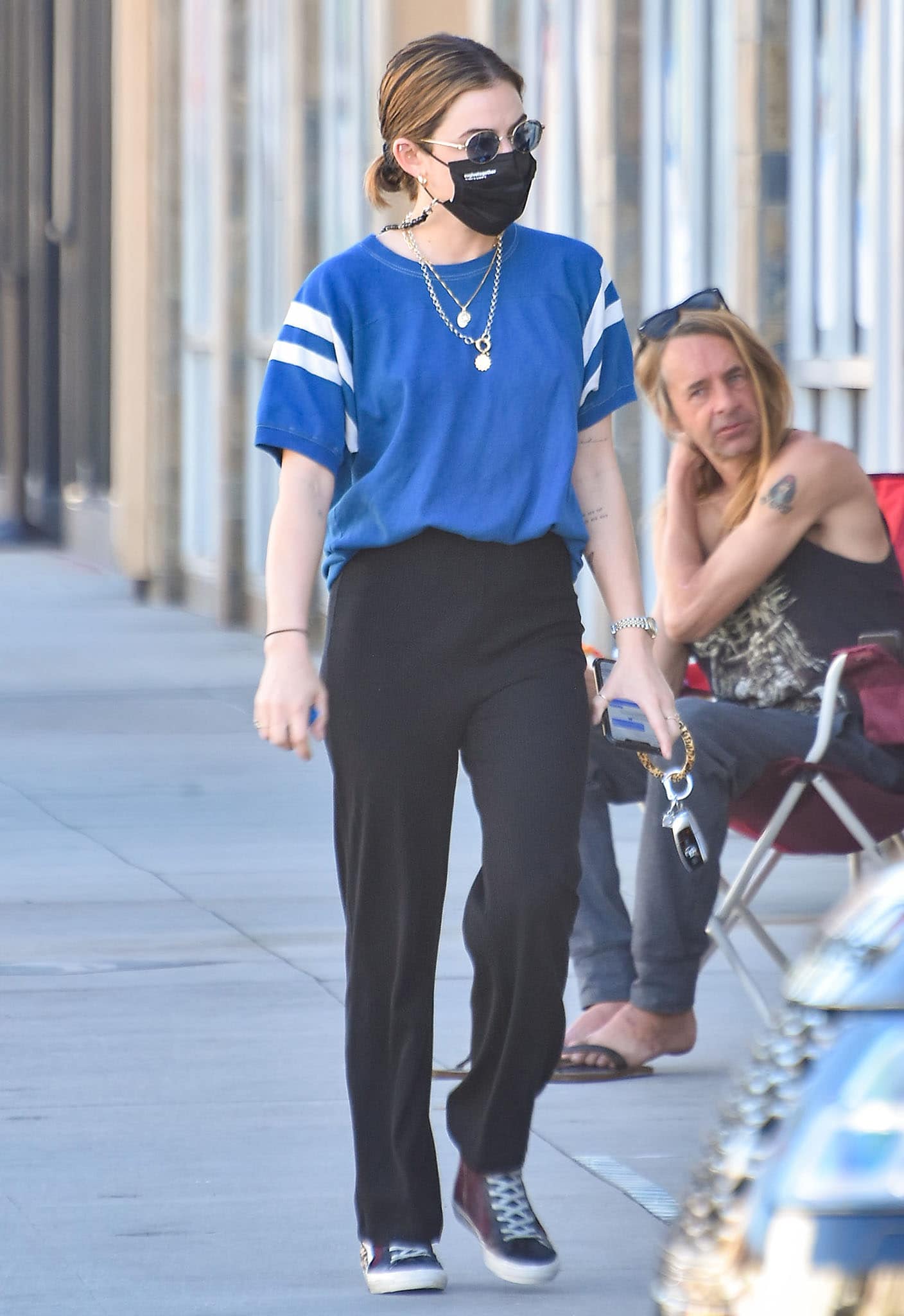 Lucy Hale grabs coffee in a blue tee and black pants combo on February 22, 2021