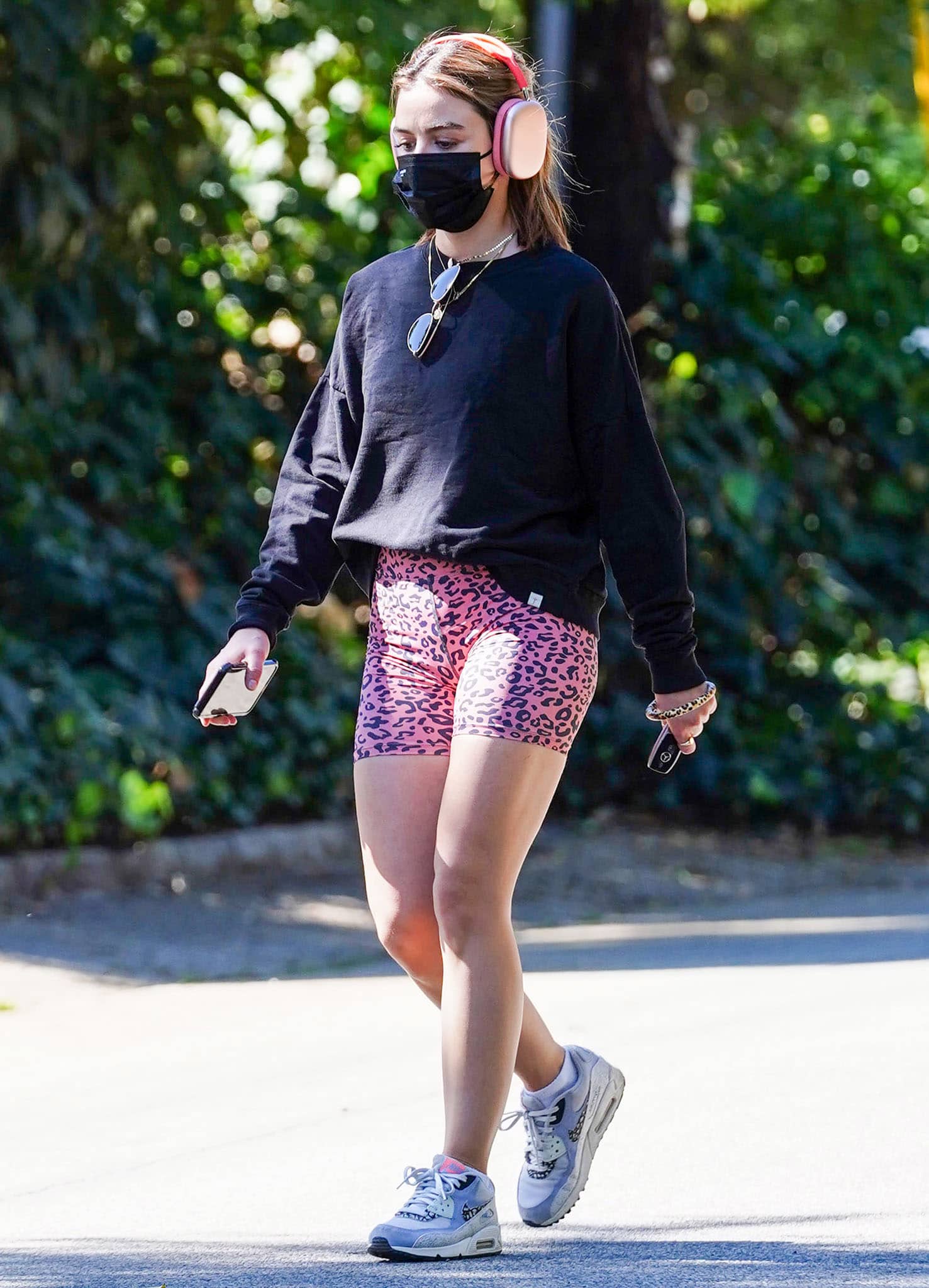 Lucy Hale goes on a solo hike in Aura 7 Activewear pink leopard shorts on February 12, 2021