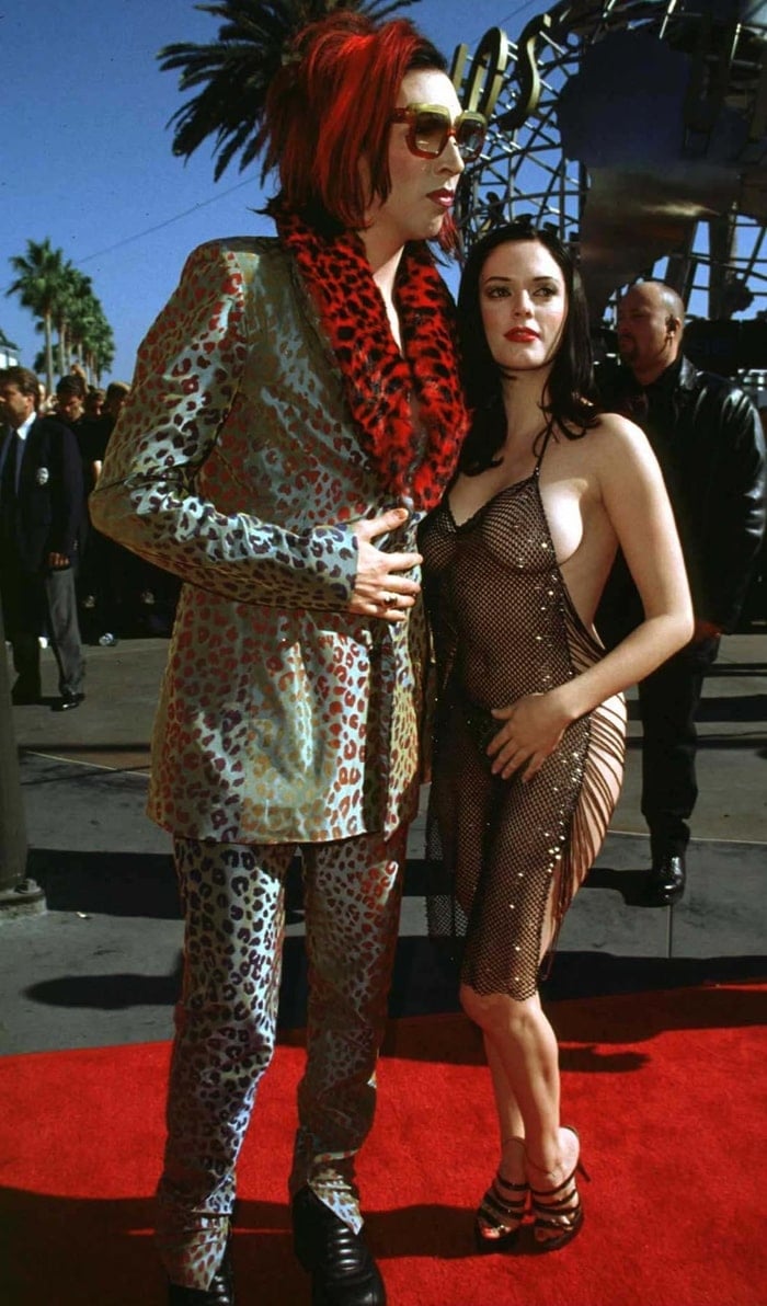 Marilyn Manson and Rose McGowan deliver one of the most daring red carpet moments in history, with Manson in a bold leopard-print suit with a red faux fur collar, and McGowan making headlines in a barely-there chainmail-style mesh dress and strappy stilettos