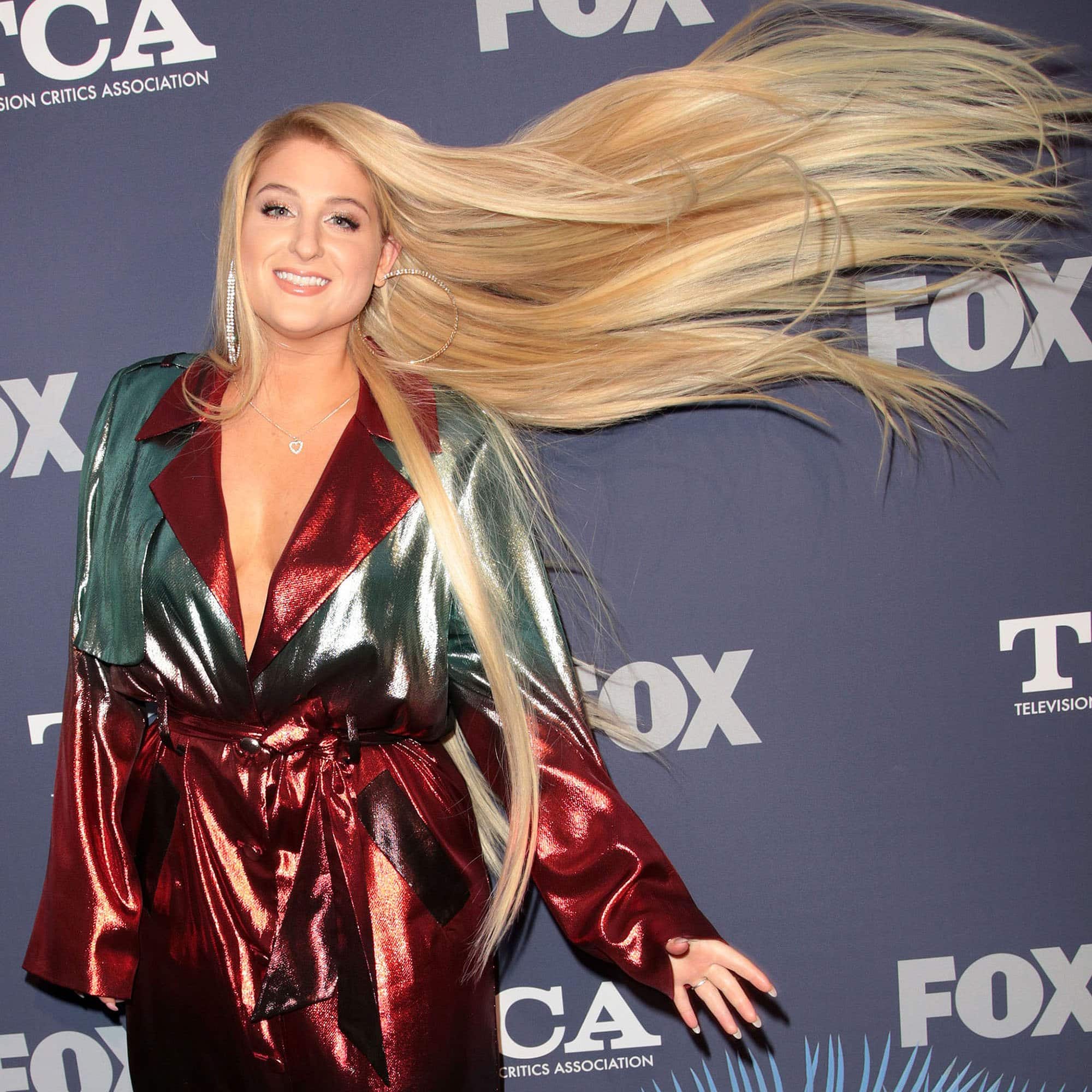 Meghan Trainor flips her long shiny blonde hair at the 2018 TCA Summer Press Tour