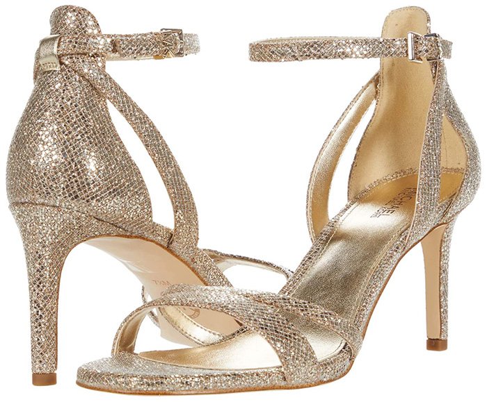 The Michael Kors Kimberly sandals, featuring a striking stiletto heel and sleek ankle strap, infuse a dash of glamour into the jogger ensemble