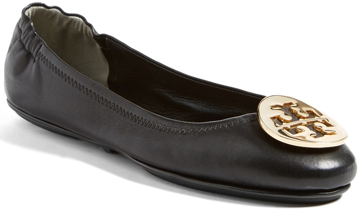 Tory Burch's Minnie travel ballet flats, adorned with the iconic logo medallion, offer a chic and comfortable option for pairing with dressy joggers