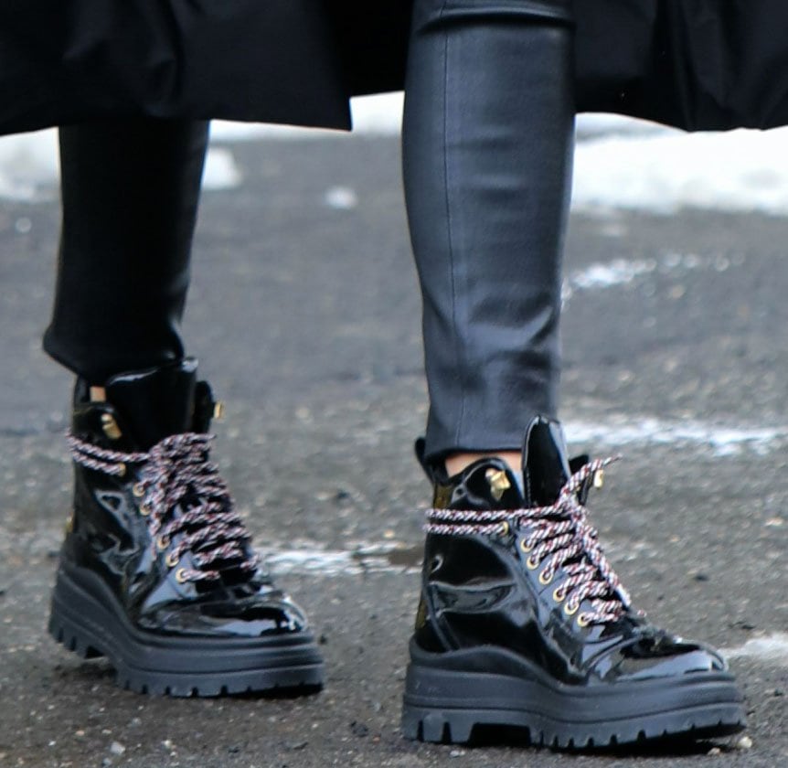 Olivia Palermo pairs her black winter ensemble with Fratelli Rossetti chunky lace-up ankle boots