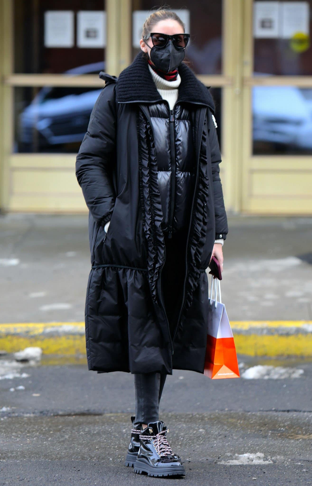 Olivia Palermo bundles up in Moncler Genius x Simone Rocha coat, vinyl jacket, and cream knit sweater