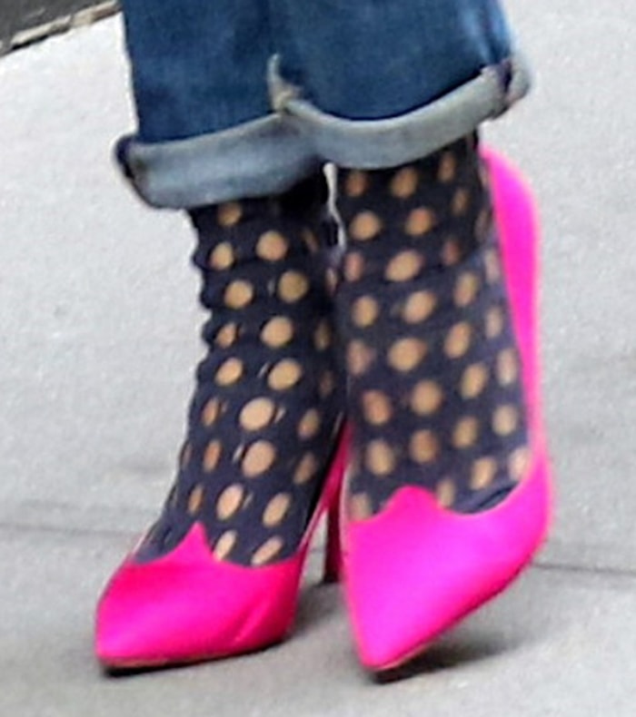 Olivia Palermo pairs cutout socks with hot pink Roger Vivier pumps